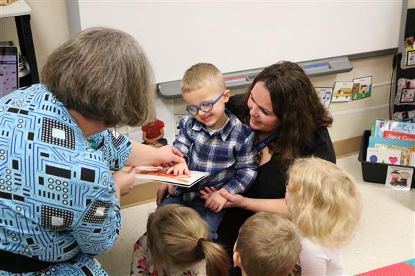 teacher working with young child