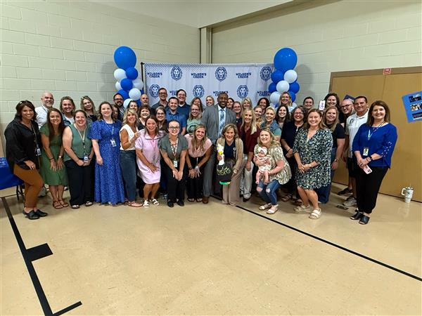 Former and current students and staff of Wilson's Creek Intermediate School pose for a group picture