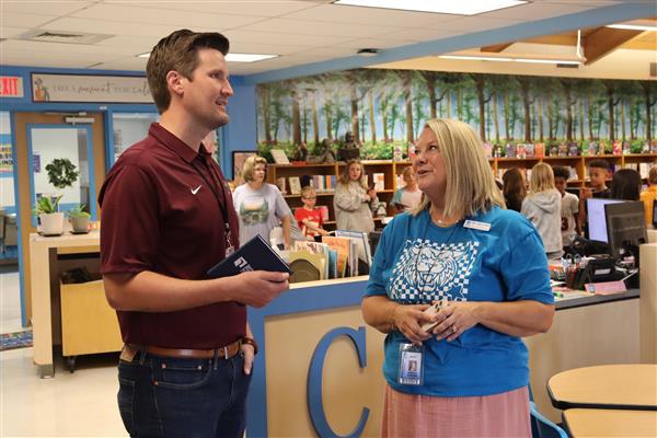 Gray Elementary Principal for a Day Kam Evans talks with Principal Angie Carder in the library.